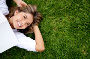 Happy woman lying in the grass
