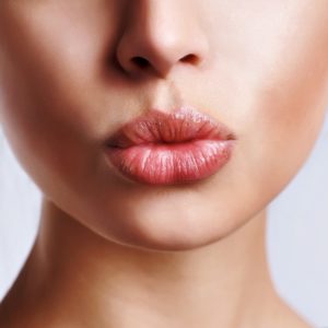 woman making kiss face