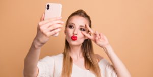 woman taking selfie on mobile phone