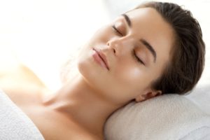 Woman on spa bed with glowing skin